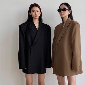 Brown oversized blazer with shoulder pads.